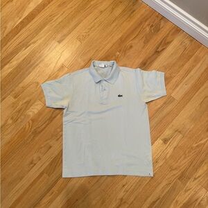 Lacoste light blue. Faded under arms